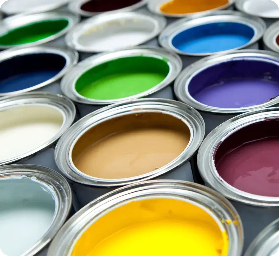 Open tins of paint in a range of bright colours