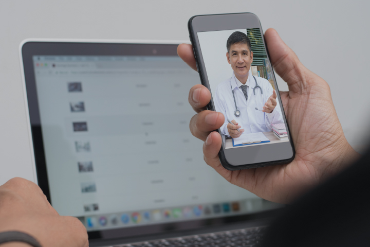 Engaged doctor on phone video chatting